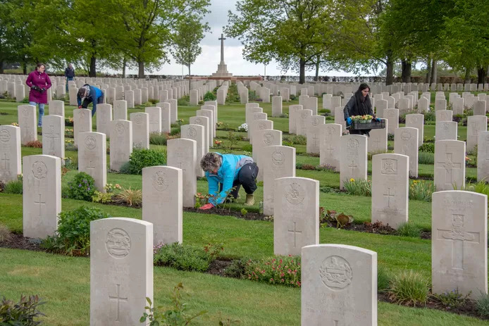 Faces to Graves volunteers are placing tulips at the graves